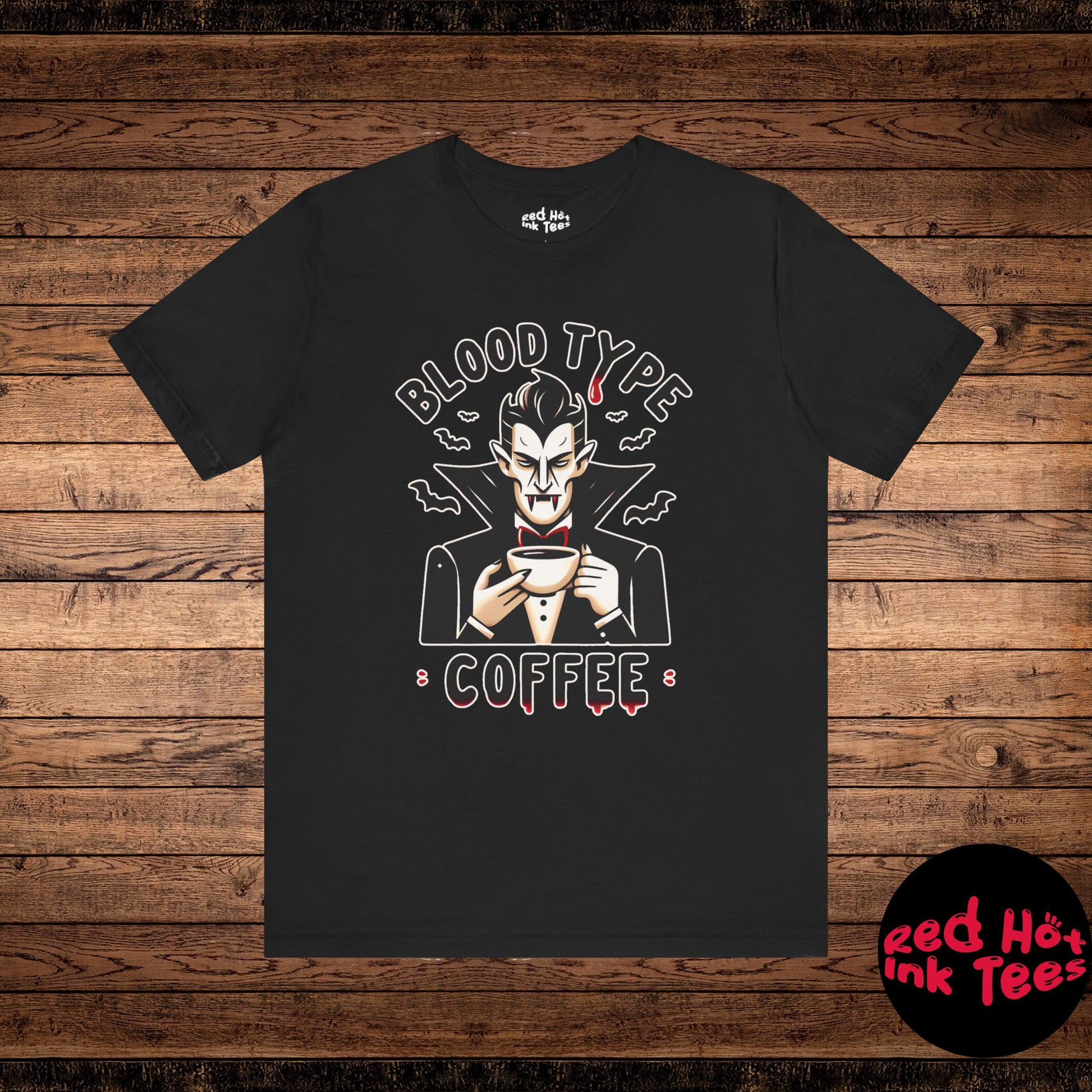 This humorous design features a vampire sipping coffee, with the phrase "Blood Type: Coffee." Perfect for both coffee lovers and vampire fans, it adds a spooky yet funny twist to any Halloween or caffeine-related apparel, combining humor with Gothic charm.